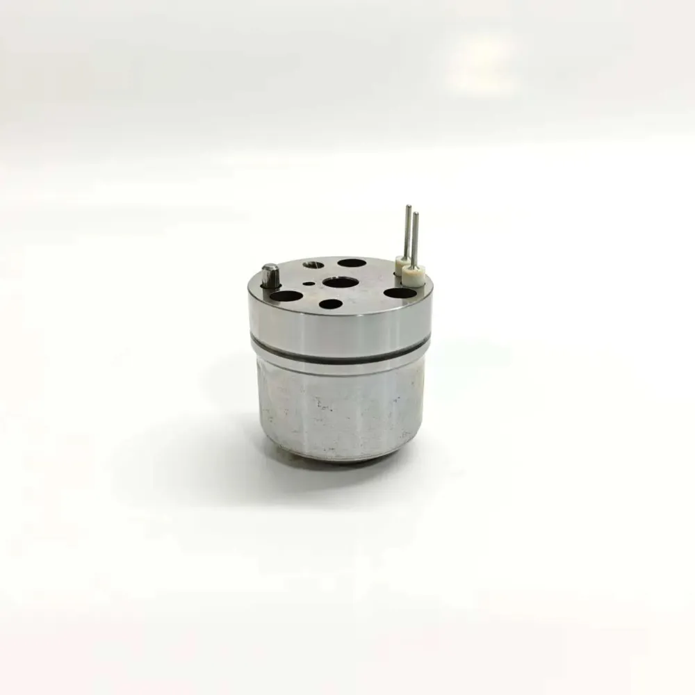 1K060372-64-7206-0372-John-Deere-RE533501-E1-EUI-Control-Valve-Main-Image 1K060372-64 7206-0372 electronic unit injector control valve suitable for John Deere E1 system applications. Upright side profile showing the full cylindrical metal housing with twin connection pins protruding from the polished top cap surface.