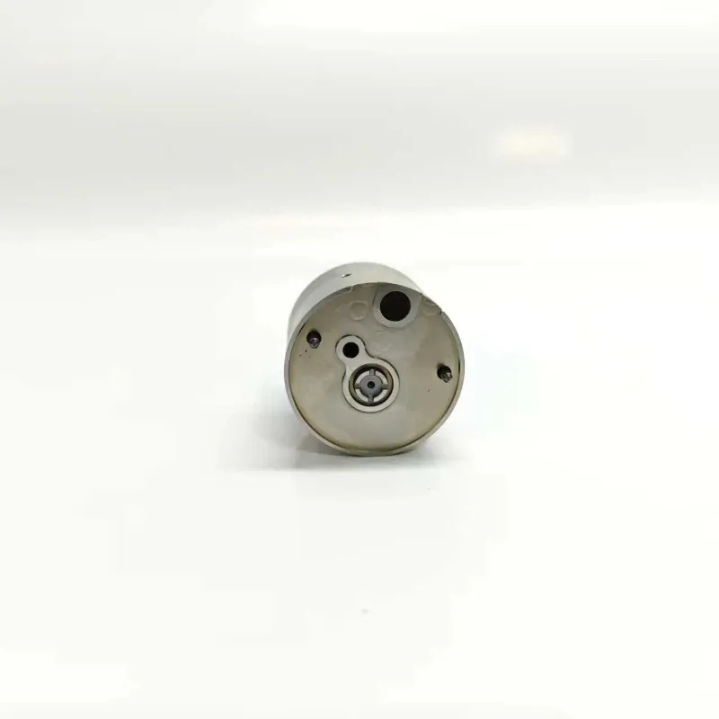 3-Hyundai-Trago-E3.5-Pump-Nozzle-Valve-Sealing-Face High-angle view of the precision machined flat sealing interface plate of the valve assembly showing fluid channels and parallel alignment indexing pins.