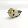 5-7135-486-Solenoid-Actuator-Top-Terminal-Pins Close-up view focusing on the cream-colored plastic terminal housing of the 7135-486 valve, showing the detailed layout of the twin electrical connector studs.