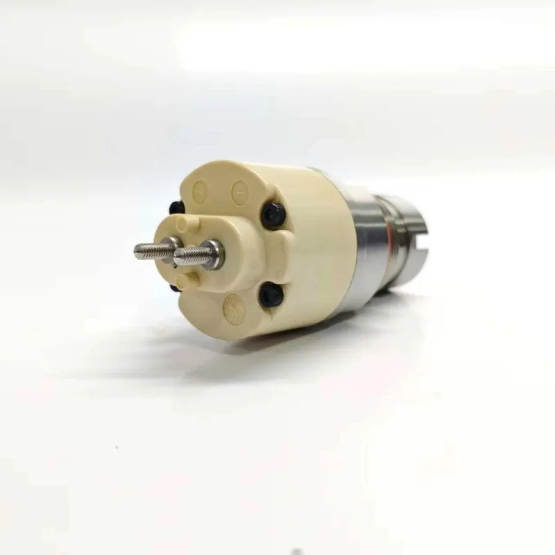 5-7135-486-Solenoid-Actuator-Top-Terminal-Pins Close-up view focusing on the cream-colored plastic terminal housing of the 7135-486 valve, showing the detailed layout of the twin electrical connector studs.