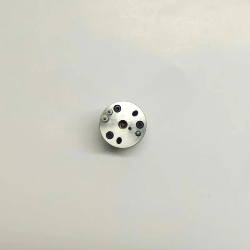 John-Deere-SE501959-Control-Valve-7206-0372-Top-View Direct top-down view of E1 electronic fuel unit injector control valve 7206-0372 showing the flat polished top surface layout, terminal pin holes, fluid ports, and anchoring pin configurations.