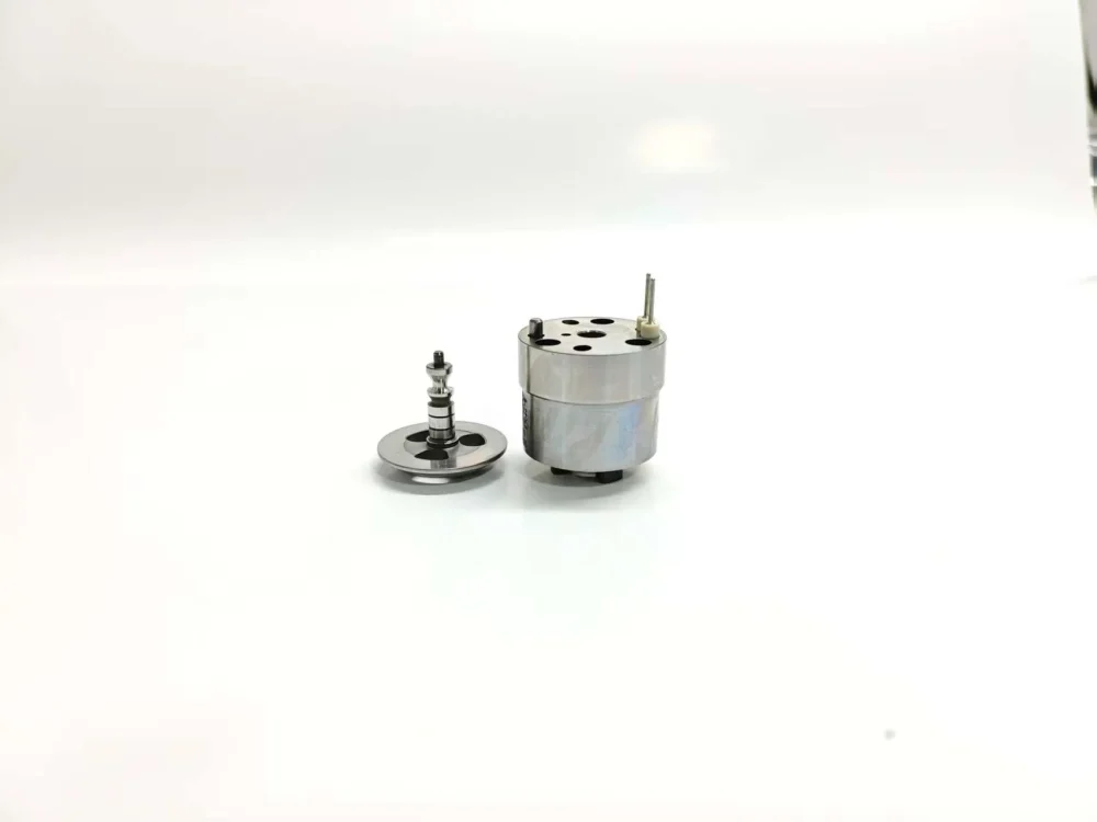 Side view of 1K060379-64 unit injector component suitable for Volvo 20440388 systems, showcasing the main solenoid actuator housing alongside its extracted precision internal valve armature core assembly.