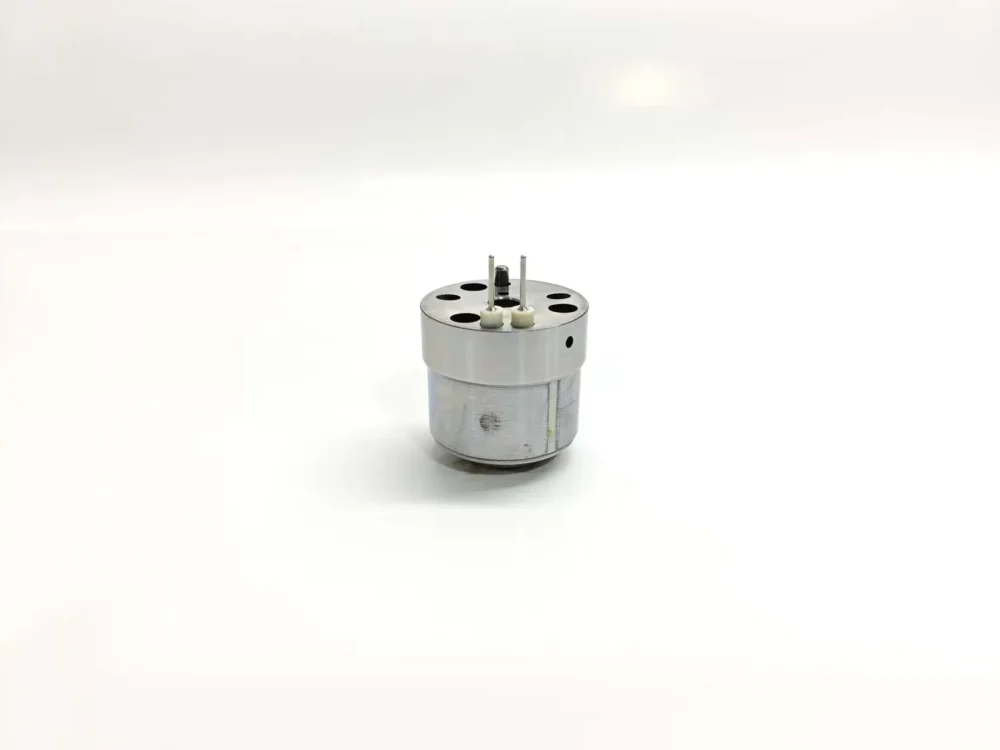 Rear side view of replacement injector control valve 1K060379-64 suitable for Volvo heavy-duty fuel systems, displaying full metallic body with vertical alignment marker lines and connection terminals.