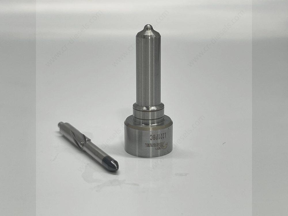 dlw-nozzle-nz7001-l221pbc-needle-disassembly-front Front view of disassembled DLW NZ7001 fuel nozzle showing the black-coated heat-treated needle valve alongside the polished nozzle body.