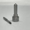 dlw-nozzle-nz7001-l221pbc-needle-disassembly-front Front view of disassembled DLW NZ7001 fuel nozzle showing the black-coated heat-treated needle valve alongside the polished nozzle body.