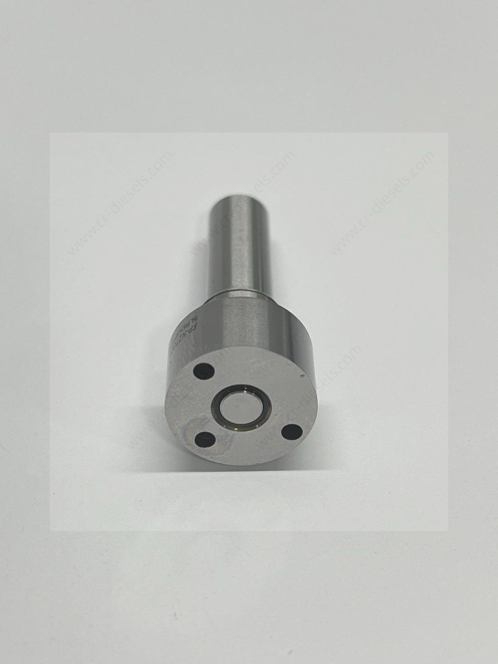 dlw-nozzle-nz7006-l322pbc-inlet-pins Macro shot of DLW NZ7006 nozzle bottom surface showing mating pin holes and fuel inlet port.